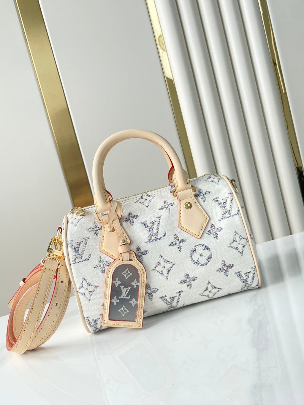 Louis Vuitton SPEEDY BANDOULIÈRE 20 IN WHITE MONOGRAM JACQUARD FABRIC AND BEIGE CALFSKIN TRIM