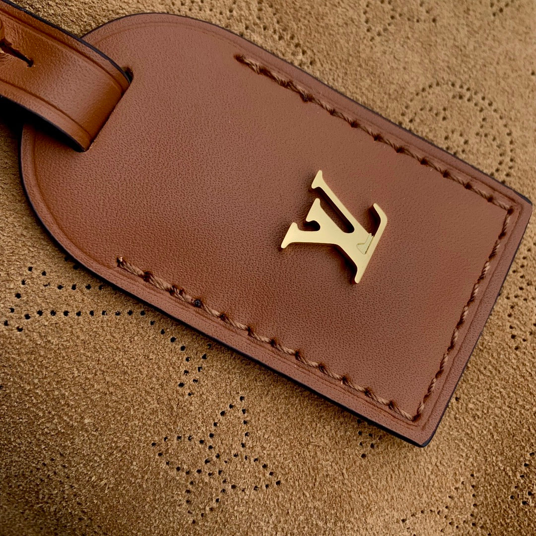 Louis Vuitton CARRYALL PM 29 IN CIDER BROWN MONOGRAM PERFORATED SUEDE AND WHITE SHEARLING TRIM