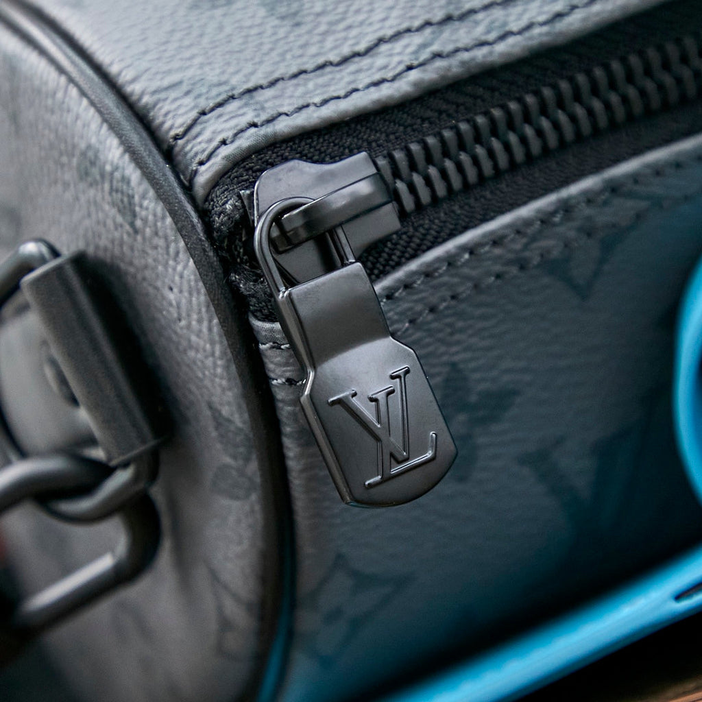 Louis Vuitton KEEPALL BANDOULIÈRE 25 IN GUN METAL MONOGRAM ECLIPSE CANVAS MIX TURQUOISE CALFSKIN