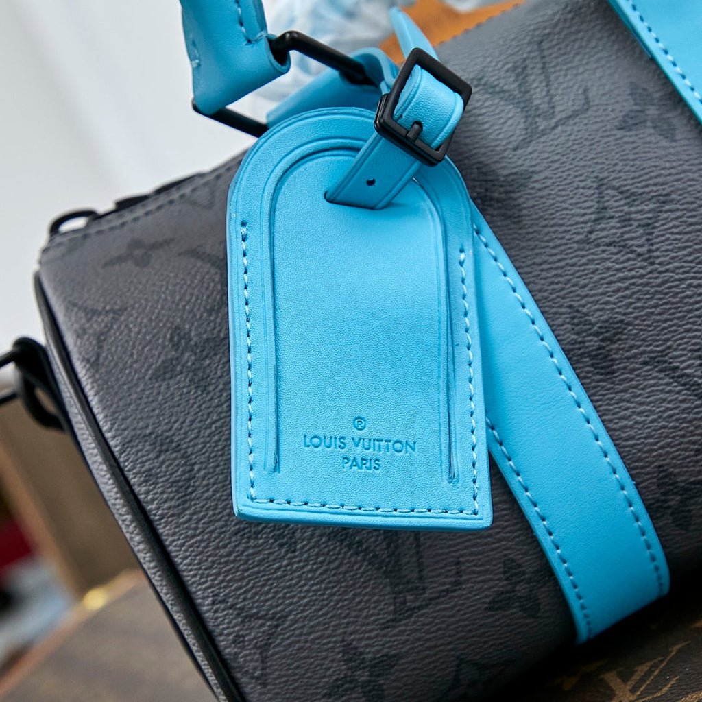 Louis Vuitton KEEPALL BANDOULIÈRE 25 IN GUN METAL MONOGRAM ECLIPSE CANVAS MIX TURQUOISE CALFSKIN